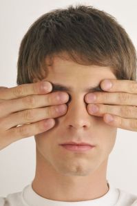 man covering eyes