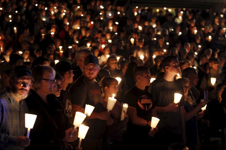 People take part in candlelight vigil following a mass shooting at Umpqua Community College in Roseburg Oregon